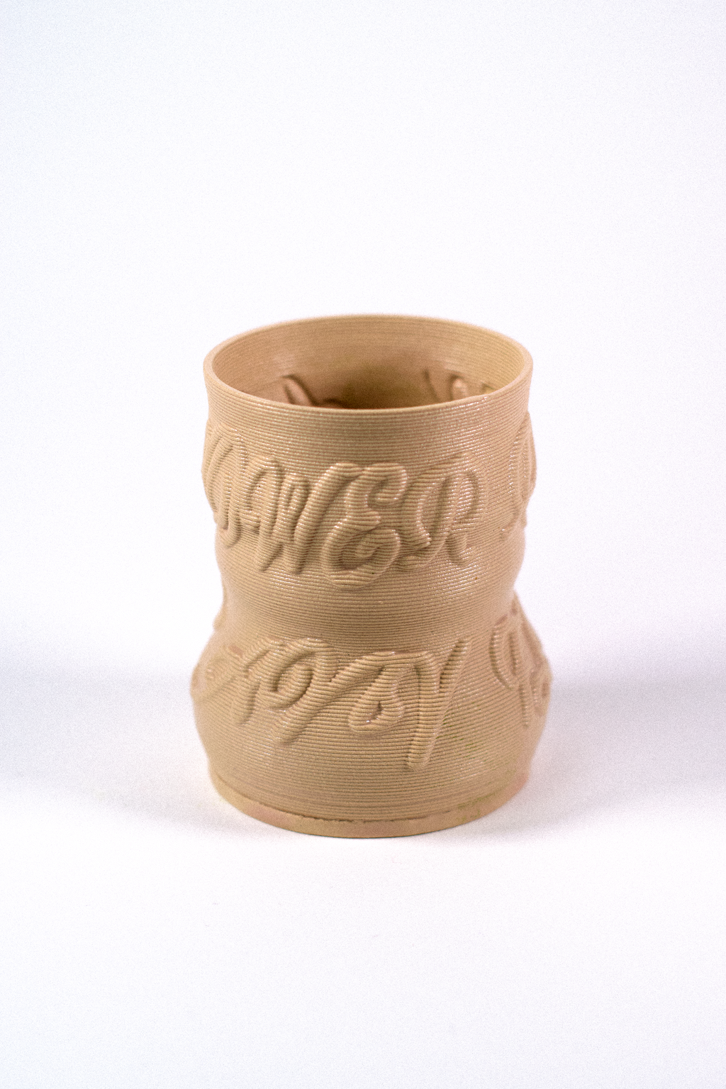 Cashew-colored 3D-printed clay matcha cup featuring a textured calligraphy pattern, designed by GLINA3.