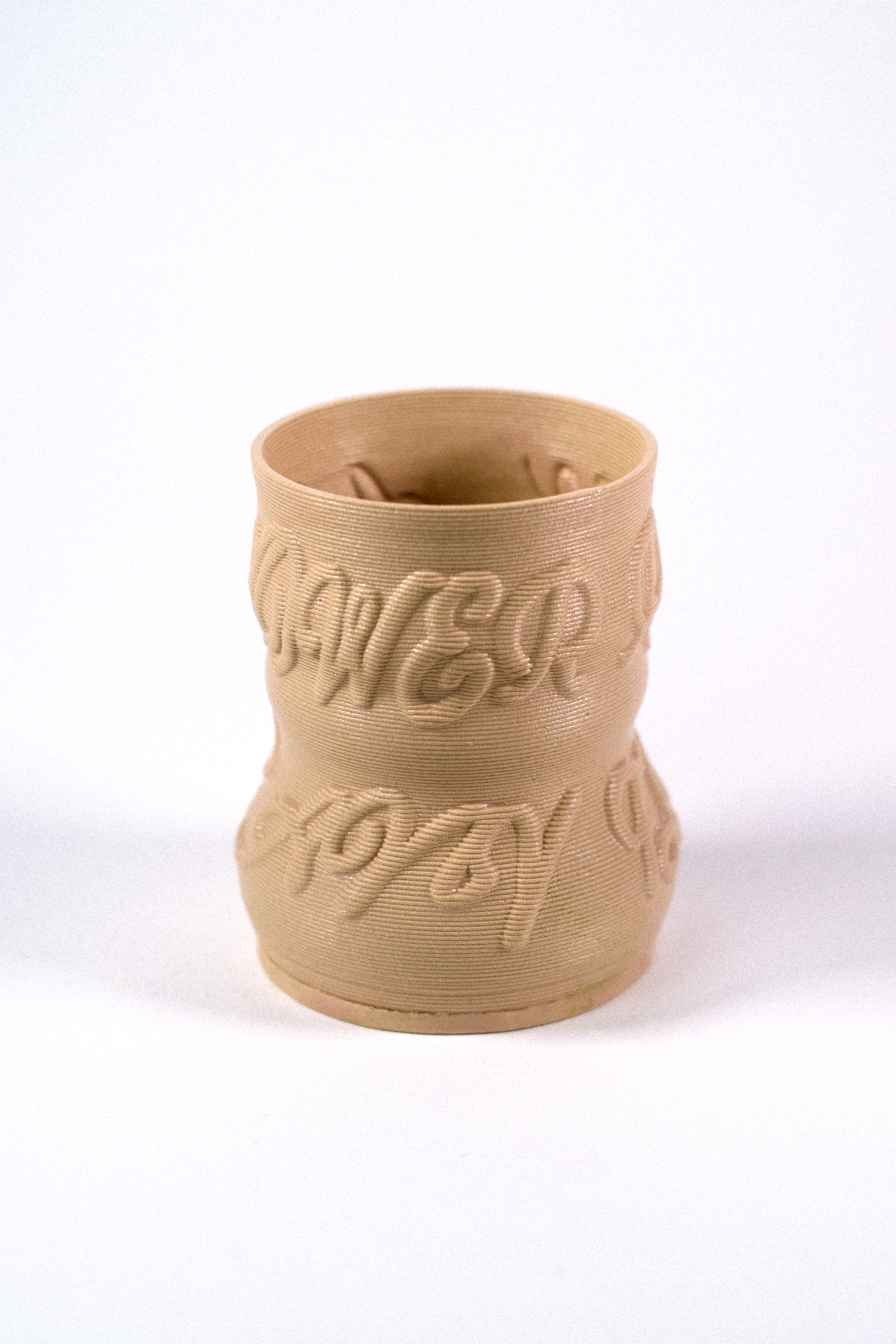 Cashew-colored 3D-printed clay matcha cup featuring a textured calligraphy pattern, designed by GLINA3.